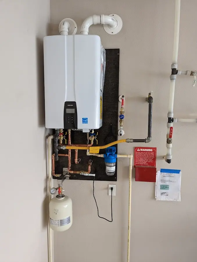 Professional plumber installing copper piping in a Stokesdale home